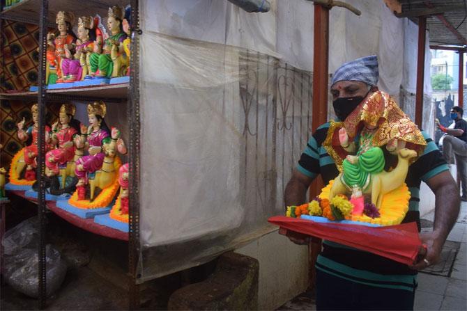 In photo: A man belonging to the Khatiyawadi community carries an idol of Goddess Dashama from Lalbaug, which will be worshipped for 9 days.