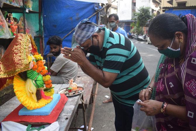 In photo: A man bows before Goddess Dashama as he visits Lalbaug to take the idol to his house. 