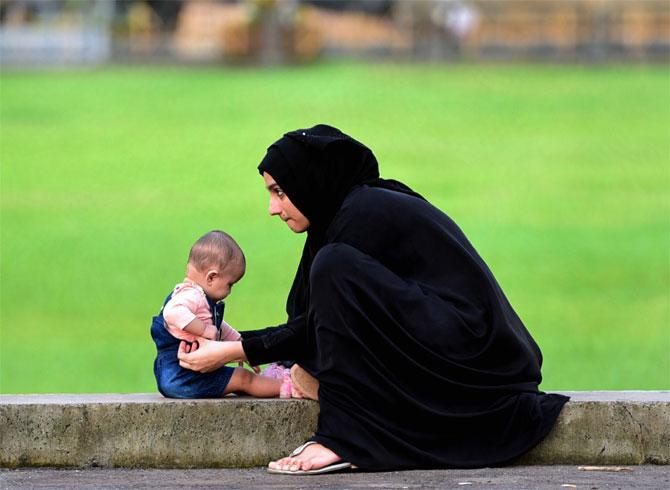 In photo: A woman playing with her child at Islam Gymkhana, Marine Drive.