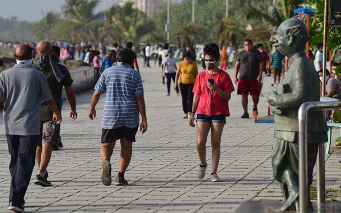 Young and old people armed with face masks, but violating social distancing norms, were snapped walking and jogging at Marine Drive