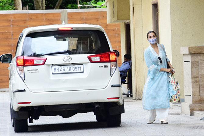 Malaika Arora looked breezy in her traditional attire of a long blue kurta which she paired with white palazzo pants and a colourful face mask as she was clicked in the Mumbai suburbs. With the lockdown restrictions lifted a little, several celebs are spotted out buy essentials or completing their work assignments. Malaika too was clicked out and about in the Bandra suburbs. All pictures/Yogen Shah