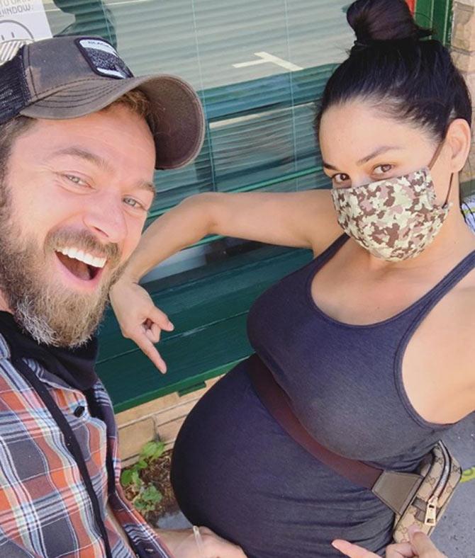 Niki Bella shared a quirky post along with this cool selfie with fiance Artem: Baby Chigvintsev is ready to make his debut! Mama is about to pop!