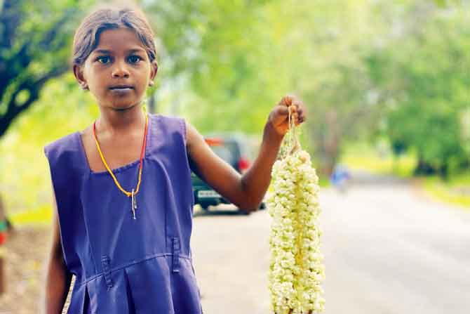 Many of the tribal kids sell flowers to earn some money. PICS/Hanif Patel