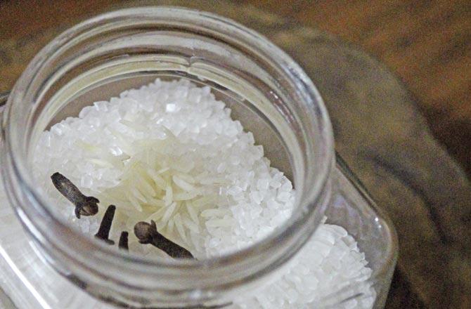 Add some cloves and raw rice grains to sugar to keep it moisture-free