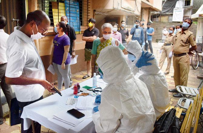 BMC doctors conduct health check-ups and swab tests at Bramnahdev society in Dadar. Pic/Ashish Raje