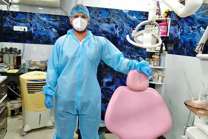  Dr Amit Salunke standing next to his dental chair in his newly opened clinic in Kurla