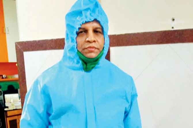Dr Mukund Shanbaug wearing a PPE kit inside his clinic