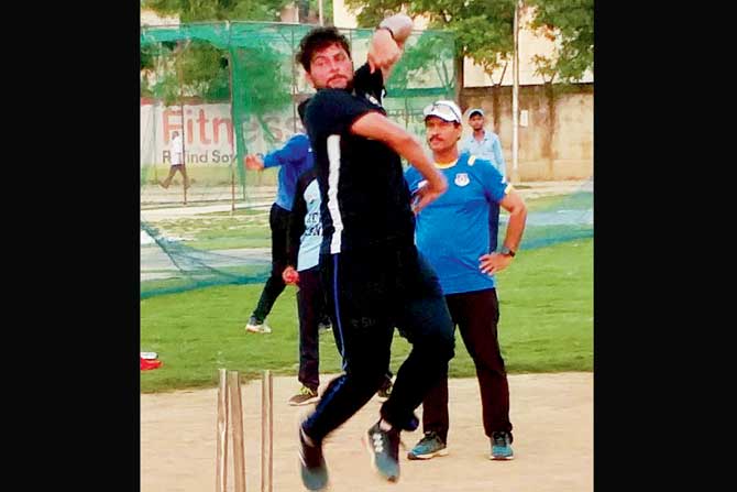 Kuldeep Yadav during a practice session with coach Kapil Pandey (in blue) in Kanpur recently