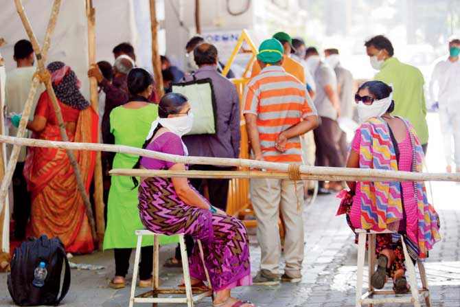 People line up at Nair Hospital for COVID-19 tests. In an ideal healthcare situation, say experts, tests should be conducted outside hospitals with only those advised by their GP, heading to the hospital for further consultations. This would decentralise hospitals and prevent over crowding