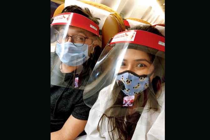 On the Air India flight with face shields and masks. Additionally, Atiya wore a PPE suit since she had been slotted a middle seat