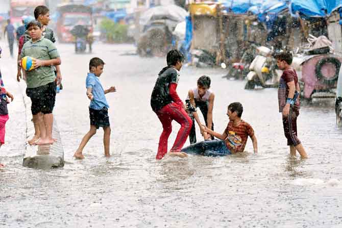 Children seem to have made the most of the water-logged road at Null Bazaar near Kumbharwada on Friday. PIC/BIPIN KOKATE