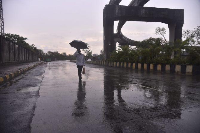 In photo: A man walks with an umbrella in Wadala as the city received first spell of rain amid lockdown.