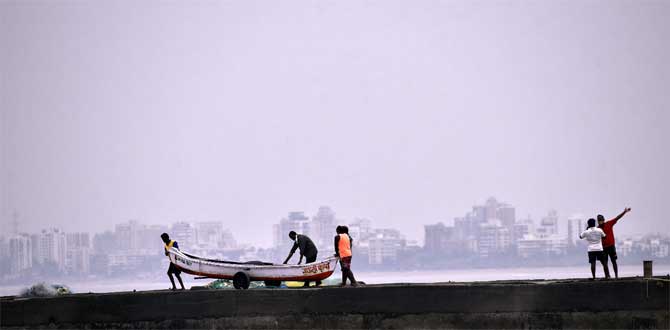The Navy has kept five flood teams and three diving teams on stand-by in Mumbai, a defence spokesperson said. These teams, trained and equipped for rescue operations, are stationed at various naval areas across Mumbai and can provide early response over a larger area, he said.
In picture: Fishermen of Khar Danda Koliwada prepare to evacuate in view of Cyclone Nisarga.