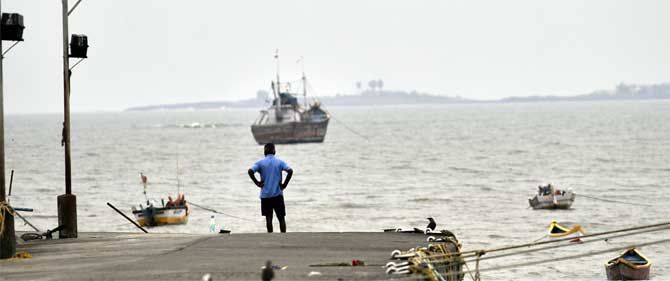 A recce of known flood-prone areas in Mumbai has been undertaken and all necessary preparations are in place, said the state government.
In picture: A man observing the sea at the Khar Danda Koliwada in Mumbai 