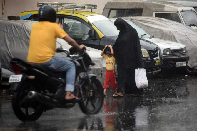 According to a statement released by the Mumbai police, as per the India Meteorological Department's warning, the city was expected to be severely impacted by the cyclone 
In picture: A woman protects her child from the rainshowers caused by the impending Cyclone Nisarga