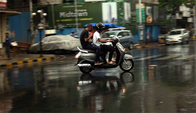 The office also said those staying in kuccha houses are being moved to safer places, adding that non-COVID hospitals are being made available.
In picture: Youngsters ride a two-wheeler at Kalbadevi as rains lash the city ahead of the Cyclone Nisarga making a landfall