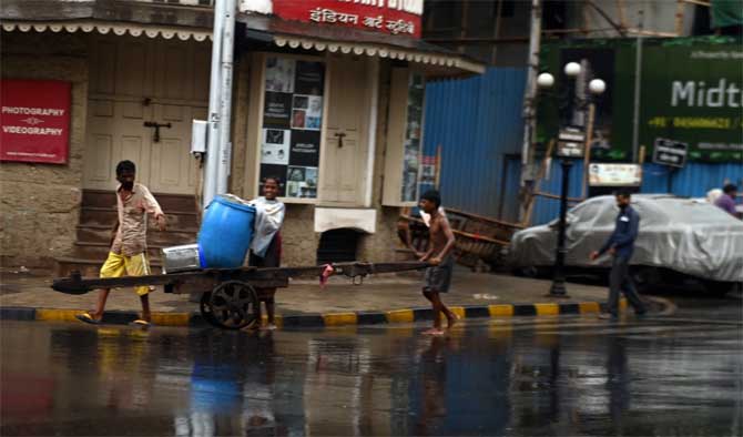 The CMO informed on Twitter that people living in the slums in the low-lying areas have been ordered to be evacuated.
In picture: Children pull a hand cart in Kalbadevi as rains lash the city ahead of the Cyclone Nisarga making a landfall