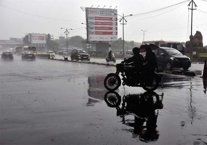 The cyclone made landfall in Raigad district on Wednesday afternoon, blowing in from the Arabian sea, with an intensity of severe cyclonic storm with wind speeds of 100-110 kmph peaking at 120 kmph.
In picture: A motorist rides at Mahim Causeway.