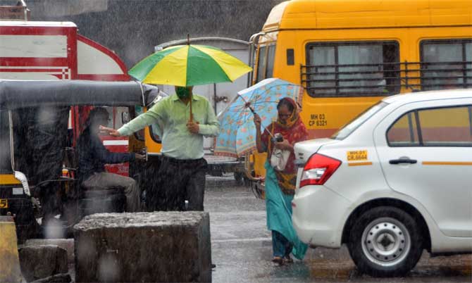 In picture: Pedestrians cross the road amid a traffic jam in Mumbai.