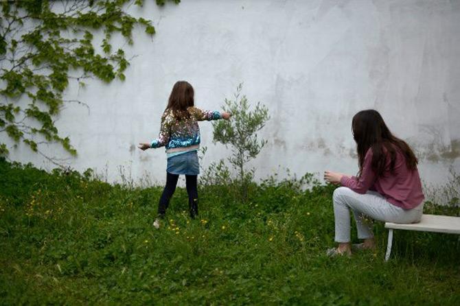 A fourteen-year-old Spanish girl and her six-year-old sister play during a break while doing their homework at home in Sevilla amid the nationwide lockdown imposed to stop the spread of the COVID-19 coronavirus.
