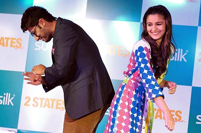 When North met South! Arjun Kapoor and Alia Bhatt pose during the promotion of their film 2 States, an adaptation of Chetan Bhagat's book of the same name, in Mumbai on March 28, 2014. Alia was just 21 when she starred in 2 States.