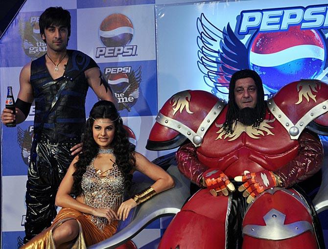 When Ranbir, Jacqueline and Sanju baba collaborated for an ad campaign of a cola brand: Sanjay Dutt and Ranbir Kapoor pose with actress Jacqueline Fernandez as they take part in a launch ceremony for a television game show in Mumbai on March 25, 2010. Five years later, Jacqueline and Ranbir romanced in the film Roy, while in 2018, Kapoor acted in Dutt's biopic - Sanju.