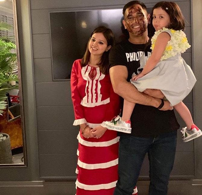 In picture: MS Dhoni and Sakshi pose for the shutterbugs along with their daughter Ziva