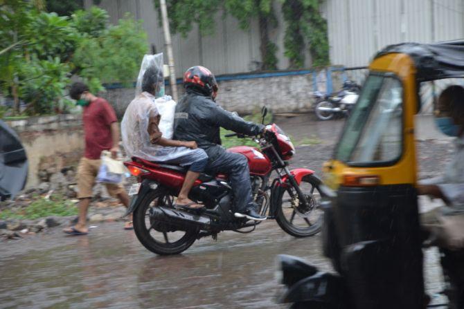 In photo: A pillion rider was spotted with his head covered with plastic bag in order to protect himself from getting drenched in Mumbai rains.