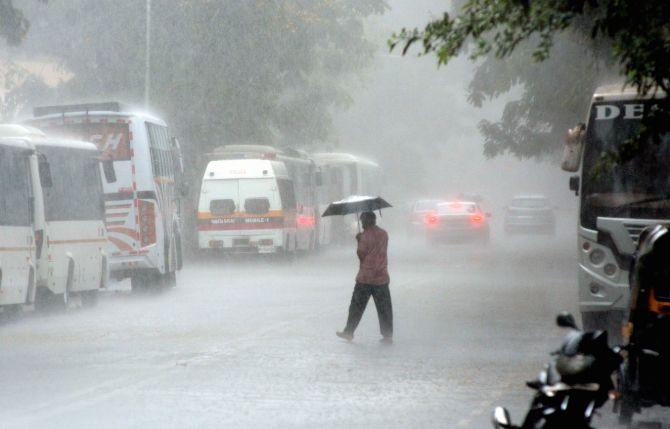 In photo: A man with an umbrella crossing the road at Thakur Village in Kandivli during heavy downpour in the city.