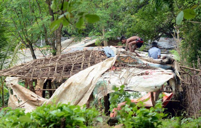 In photo: A young tribal boy repairs a roof at Aarey Colony in Goregaon as the city witnessed heavy spells of rains on Thursday.
