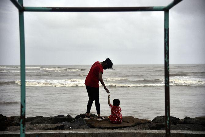 At Bandra's Carter Road promenade, a mother and a daughter were snapped by mid-day lens man enjoying the showers of the rains. 