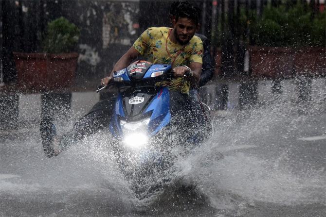 In photo: A biker maneuvers his bike through the water-logged streets of Bandra as the city received heavy rainfall.