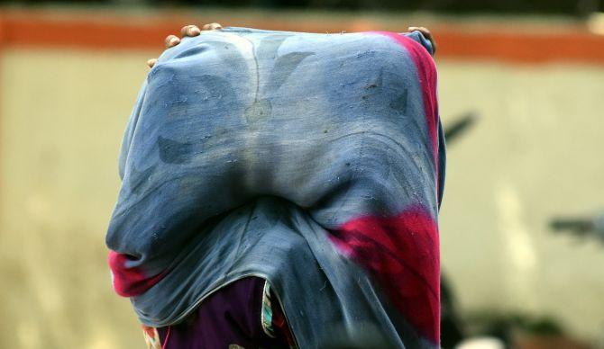 In photo: A mother covers her child with a dupatta to protect from the sun's rays during the annual solar eclipse in Bandra.