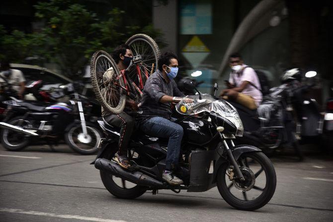In photo: A bike for each rider! Pillion rider carrying a cycle as he rides on a motorcylce in Bandra. 
According to fresh guidelines issued by the Maharashtra government, two-wheelers are allowed to ply with a single rider and no pillion rider is allowed