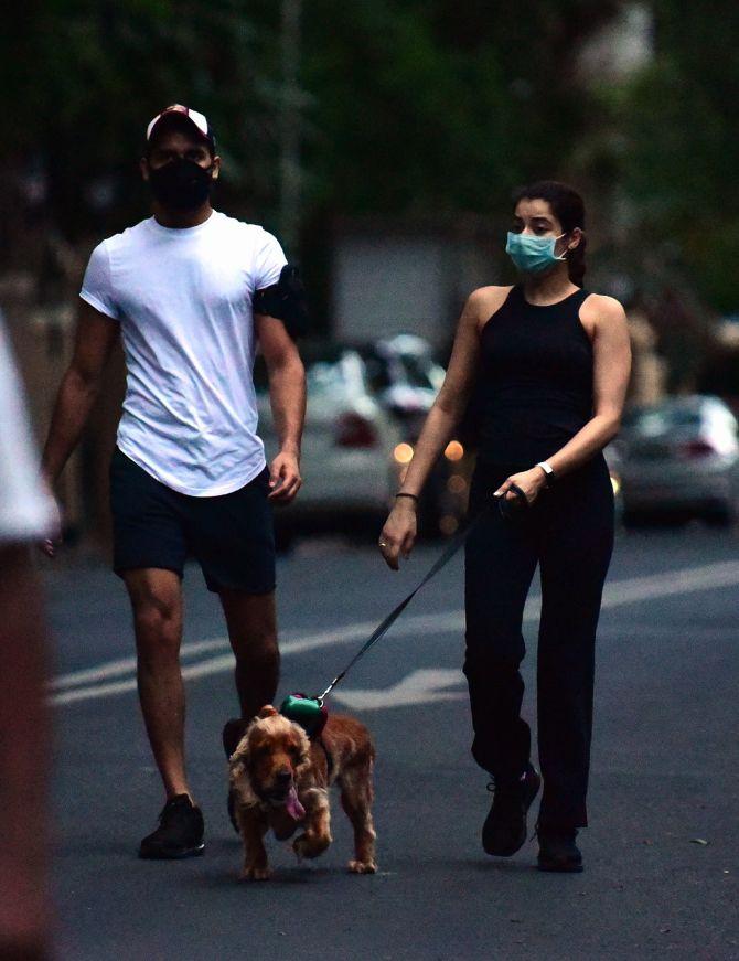 In photo: A couple stroll near Hanging Gardens with their pet in South Mumbai.