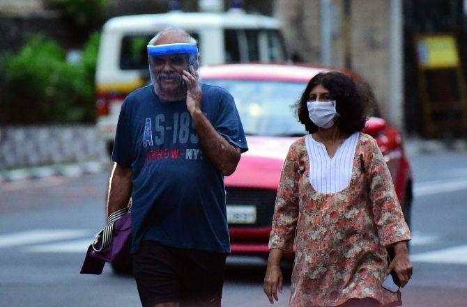 In photo: A couple with protective face gear on the streets of Mumbai