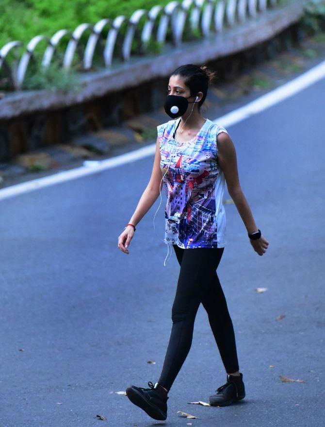 In photo: A woman wearing a N95 mask in South Mumbai.