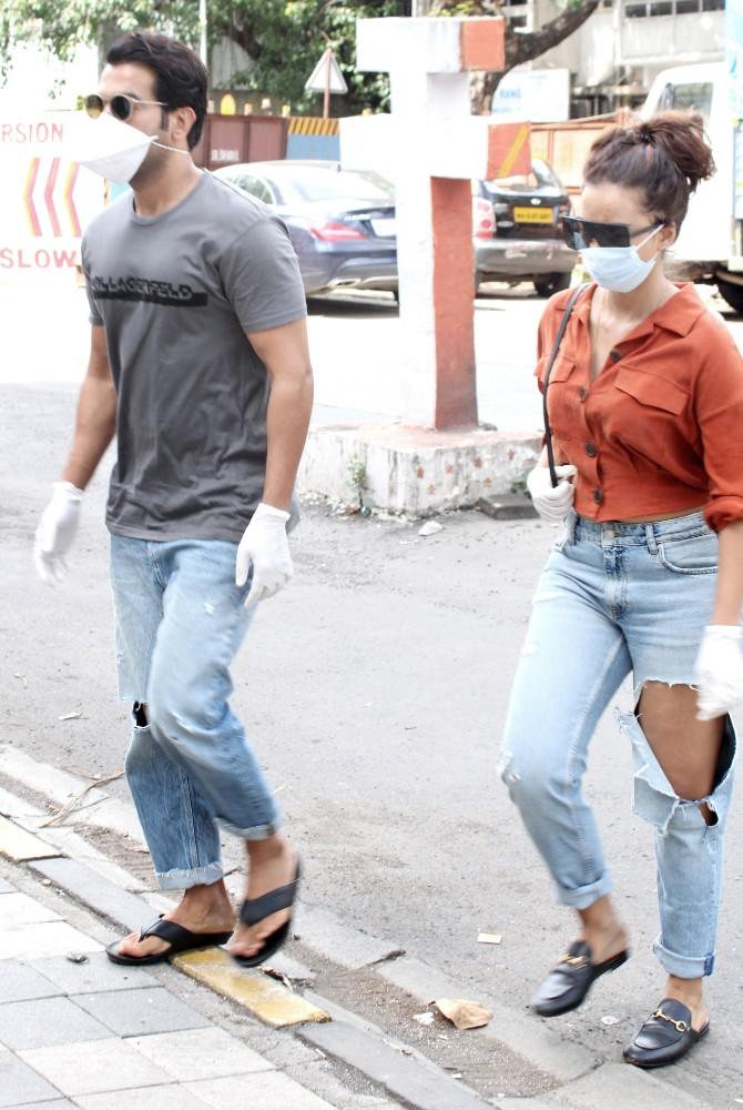 For the outing, Rajkummar opted for grey t-shirt and ripped jeans while his beau donned a red shirt and denims and teamed up her outfit with flunky brown handbag. The couple twinned in their black flip flops.