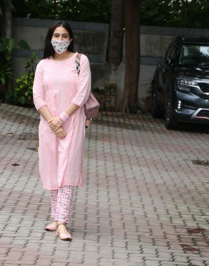 Sara Ali Khan was clicked at director Aanand L Rai's office in Andheri. The actress opted for simple-yet-sober pink salwar kameez and multi-coloured mask for the outing.