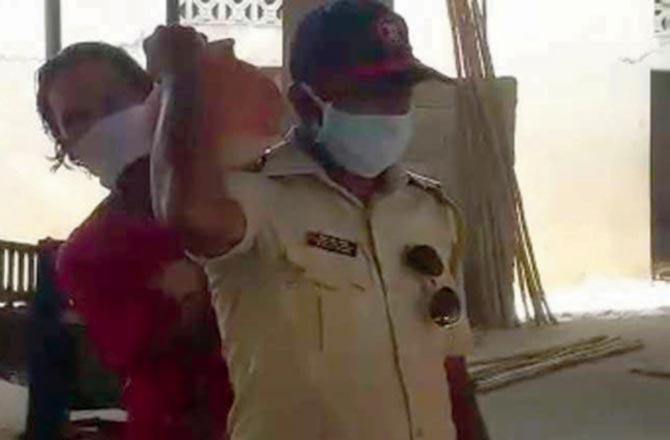 Constable Subhash Shinde helps with a cremation