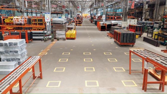 Blocks marked on the ground for employees to stand apart at a Godrej & Boyce facility