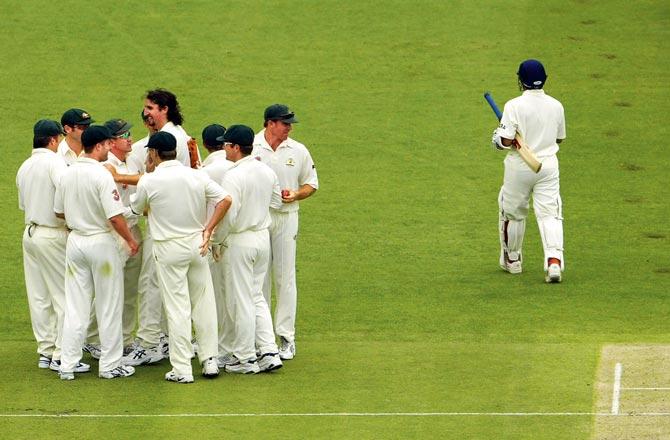 Sachin Tenduklar walks back after being adjudged LBW by umpire Steve Bucknor off Australia pacer Jason Gillespie on Day Four of the first Test at the Gabba in December