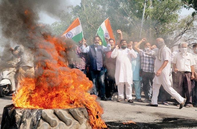 Demonstrators burn a tyre and block the Jammu-Poonch highway during a protest against China on Wednesday. Pic/PTI