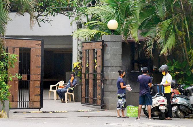 Residents of Silver Arch Apartments on Nepean Sea Road collect parcels at the main gate, on Sunday