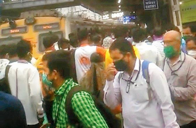 People crowd at Malad station to board a train