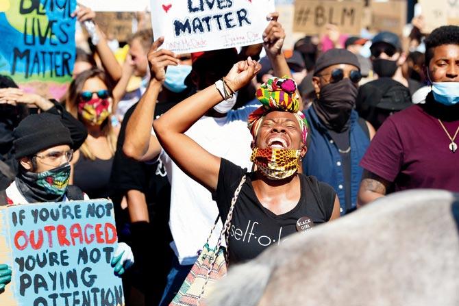A woman leads a crowd of protesters in support of George Floyd and against police brutality, in San Francisco on Wednesday. PIC/AFP