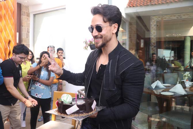 Tiger Shroff was seen wearing a basic black t-shirt, paired with a casual jacket and blue denim.