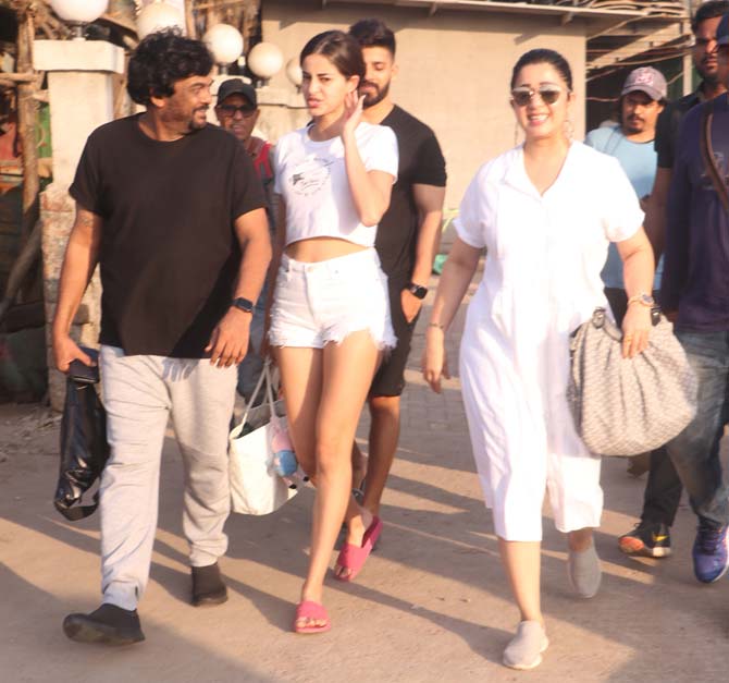 Ananya looked pretty in her white t-shirt teamed with matching ripped shorts and pink flip flops. She was joined by South Indian actress Charmi for the outing.