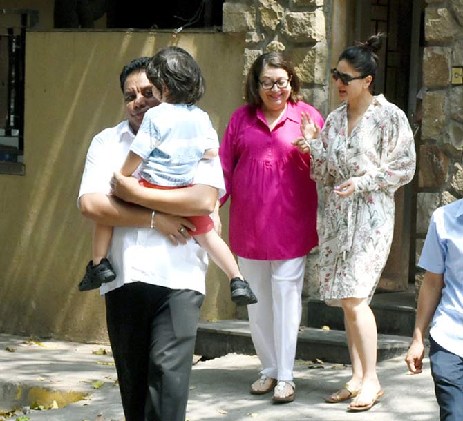 Babita was also clicked wearing a pretty pink shirt, paired with white pants and classy sandals.