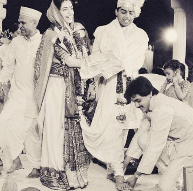 For their wedding, which took place in the 1980s, Nita Ambani opted for a white and red silk saree which she complemented with a single choker necklace, bangles, and a nose ring. While Mukesh made for a picture-perfect Gujarati groom in a kurta, pyjama, and a turban.








